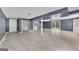 Open basement with tile flooring, laundry, stairs, and glass doors to outdoor area at 178 Castleair Ne Dr, Kennesaw, GA 30144