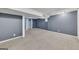 Carpeted basement with ample space, natural light, and neutral walls at 178 Castleair Ne Dr, Kennesaw, GA 30144