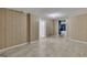 Finished basement space with paneled walls, tile floors, and access to additional rooms at 178 Castleair Ne Dr, Kennesaw, GA 30144