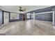 Large finished basement with tile flooring, support beams, and window views at 178 Castleair Ne Dr, Kennesaw, GA 30144