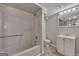 Well-lit basement bathroom featuring a shower-tub combo, toilet, and vanity with mirror at 178 Castleair Ne Dr, Kennesaw, GA 30144