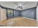 A spacious bedroom with hardwood floors, ceiling fan, and natural light at 178 Castleair Ne Dr, Kennesaw, GA 30144