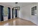 Dining room featuring hardwood floors, elegant lighting, and a built-in cabinet at 178 Castleair Ne Dr, Kennesaw, GA 30144