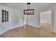 Dining room featuring hardwood floors, elegant lighting, built-in cabinet, and adjacent doorway at 178 Castleair Ne Dr, Kennesaw, GA 30144
