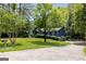 Quaint home showcasing a lush lawn, classic design, a mailbox with a number, and a long driveway at 178 Castleair Ne Dr, Kennesaw, GA 30144