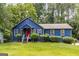 Charming blue home with a well-maintained lawn and landscaped greenery all around at 178 Castleair Ne Dr, Kennesaw, GA 30144