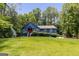 Charming blue home featuring a well-maintained lawn, traditional design, and eye-catching red front door at 178 Castleair Ne Dr, Kennesaw, GA 30144