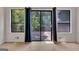 Bright living room featuring hardwood floors, a sliding door to deck, and natural light at 178 Castleair Ne Dr, Kennesaw, GA 30144