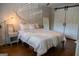 Cozy bedroom featuring hardwood floors, a comfortable bed, and sliding barn doors at 37 La Rue Nw Pl, Atlanta, GA 30327