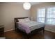 Serene bedroom with hardwood floors, large windows, and a cozy bed at 37 La Rue Nw Pl, Atlanta, GA 30327