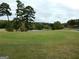 Scenic view of the golf course, showing the rolling green hills, pond, and mature trees at 37 La Rue Nw Pl, Atlanta, GA 30327