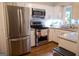 Updated kitchen featuring stainless steel appliances, granite counters, and white cabinets at 37 La Rue Nw Pl, Atlanta, GA 30327