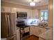Bright kitchen featuring stainless steel appliances, granite counters, and classic white cabinets at 37 La Rue Nw Pl, Atlanta, GA 30327