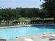 Community pool surrounded by lounge chairs, tables and lush landscaping, perfect for relaxation at 37 La Rue Nw Pl, Atlanta, GA 30327