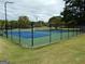 Outdoor tennis courts with green and blue surfaces and surrounding dark fences at 37 La Rue Nw Pl, Atlanta, GA 30327