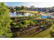 Aerial view showcasing a pond, putting green and walking trails in a landscaped community at 100 Carlyle Ln, Fayetteville, GA 30214