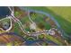 An aerial view shows a creek bed winding through a landscaped green space at 100 Carlyle Ln, Fayetteville, GA 30214