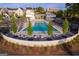 Aerial view of the community pool featuring ample lounge seating, mature trees, and manicured landscaping at 100 Carlyle Ln, Fayetteville, GA 30214