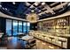 Stylish bar area with a chic lighting fixture, ample seating, and a fully stocked bar at 100 Carlyle Ln, Fayetteville, GA 30214