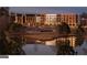 Scenic view of a multi-story building overlooking a pond with landscaped grounds at 100 Carlyle Ln, Fayetteville, GA 30214