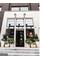 Chic boutique entrance with stylish planters and eye-catching black and white facade at 100 Carlyle Ln, Fayetteville, GA 30214