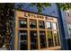 Charming storefront of Leyland Blue, featuring a wooden-framed glass facade and blue brick exterior at 100 Carlyle Ln, Fayetteville, GA 30214