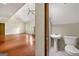 View from bathroom into the living room with a fireplace and hardwood floors at 70 Juliana Dr, Ellenwood, GA 30294
