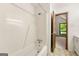 Bright white bathroom with a full shower and bathtub at 70 Juliana Dr, Ellenwood, GA 30294