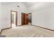 A large bedroom with multiple doors and neutral carpeting at 70 Juliana Dr, Ellenwood, GA 30294