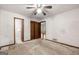 Bedroom features a ceiling fan, closet, and natural light at 70 Juliana Dr, Ellenwood, GA 30294