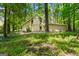 Two-story home nestled in a lush, wooded setting with a charming exterior and ample natural light through large windows at 70 Juliana Dr, Ellenwood, GA 30294