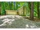 Exterior view of a house with a large driveway and wooded surroundings at 70 Juliana Dr, Ellenwood, GA 30294
