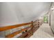 Long hallway with wood railing and vaulted ceiling with natural light at 70 Juliana Dr, Ellenwood, GA 30294