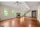 Open living area with hardwood flooring and a stone fireplace at 70 Juliana Dr, Ellenwood, GA 30294
