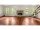Living room with wood flooring, stone fireplace, and windows at 70 Juliana Dr, Ellenwood, GA 30294