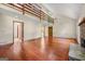 Spacious open-concept living room, featuring wood floors, stairs to upper level, and entryways to other rooms at 70 Juliana Dr, Ellenwood, GA 30294