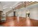 Open-concept living room with wood floors, stone fireplace, and stairs leading to the second floor at 70 Juliana Dr, Ellenwood, GA 30294