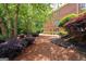 Backyard with greenery including trees, bushes, and pine straw on the ground at 3045 Moss Stone Lane Sw Ln, Marietta, GA 30064