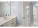 Bathroom featuring a large vanity with white cabinets, a framed mirror, and white painted doors at 3045 Moss Stone Lane Sw Ln, Marietta, GA 30064