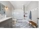 Bright bathroom features a glass enclosed shower and decorative patterned tile flooring at 3045 Moss Stone Lane Sw Ln, Marietta, GA 30064
