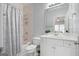 Well-lit bathroom with a combined shower and bathtub, a white vanity, and neutral tile at 3045 Moss Stone Lane Sw Ln, Marietta, GA 30064