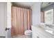 Bathroom with a shower and tub combo, white toilet and vanity. A window with blinds lets in natural light at 3045 Moss Stone Lane Sw Ln, Marietta, GA 30064