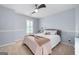 Bedroom featuring carpeted floors, a fan with lights, and a bed with pink bedspread at 3045 Moss Stone Lane Sw Ln, Marietta, GA 30064