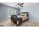 Bedroom with comfortable bedding, soft carpet, ceiling fan and a view to the outdoors at 3045 Moss Stone Lane Sw Ln, Marietta, GA 30064