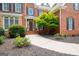 Inviting entrance featuring brick facade, covered porch, and lush landscaping detail at 3045 Moss Stone Lane Sw Ln, Marietta, GA 30064