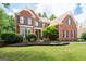 Brick two-story home with manicured lawn and attractive landscaping, showcasing curb appeal at 3045 Moss Stone Lane Sw Ln, Marietta, GA 30064