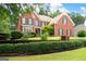 Brick two-story home featuring manicured lawn and dark shutters, enhancing curb appeal at 3045 Moss Stone Lane Sw Ln, Marietta, GA 30064