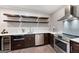 Kitchen boasts stainless steel appliances, floating shelving, and a wine fridge for entertaining at 3045 Moss Stone Lane Sw Ln, Marietta, GA 30064