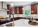 Spacious kitchen island with stainless steel sink and faucet, modern appliances, and custom cabinetry at 3045 Moss Stone Lane Sw Ln, Marietta, GA 30064