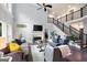 Spacious living room showcasing hardwood floors, a staircase, and a cozy fireplace at 3045 Moss Stone Lane Sw Ln, Marietta, GA 30064